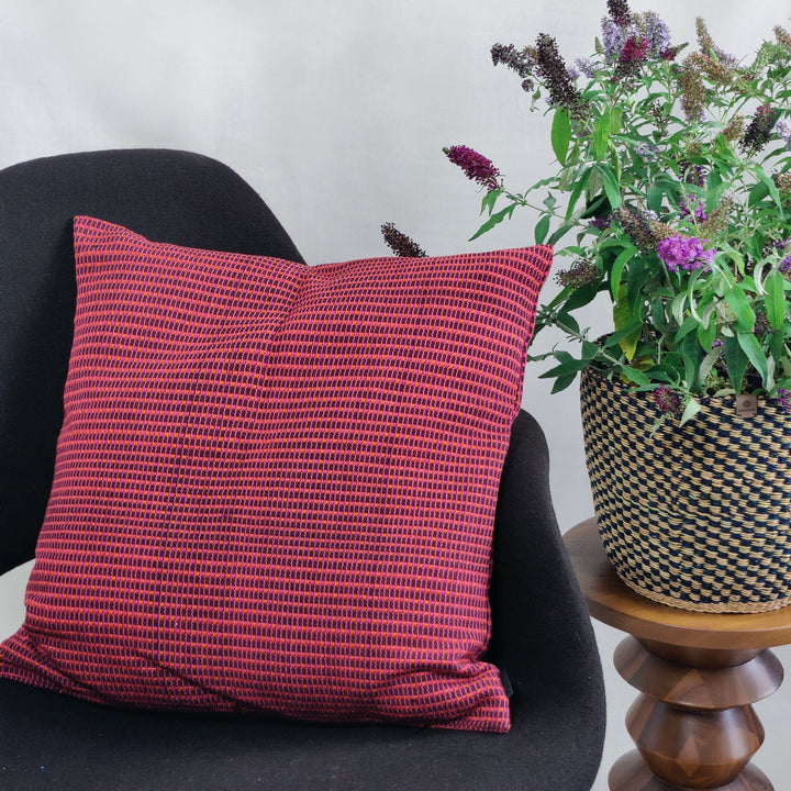 Woven cushion ABILITY (wine red, pink, orange)